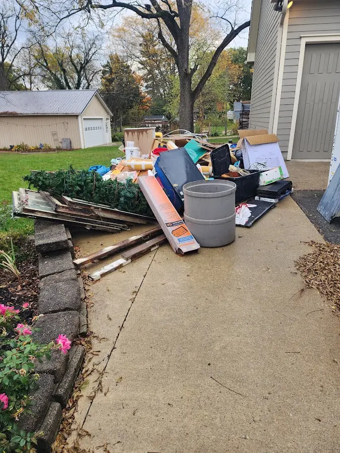 Dumpster being loaded with debris for Roofing Dumpster Rental in Brecksville